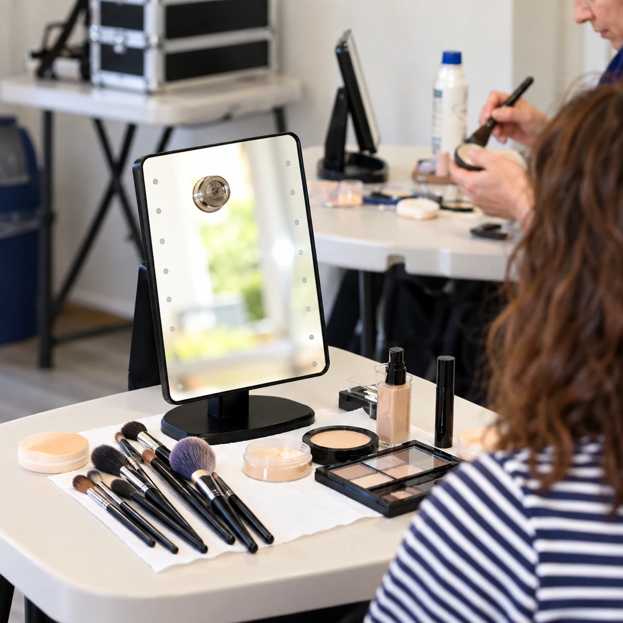 Participants working at their makeup stations during a session